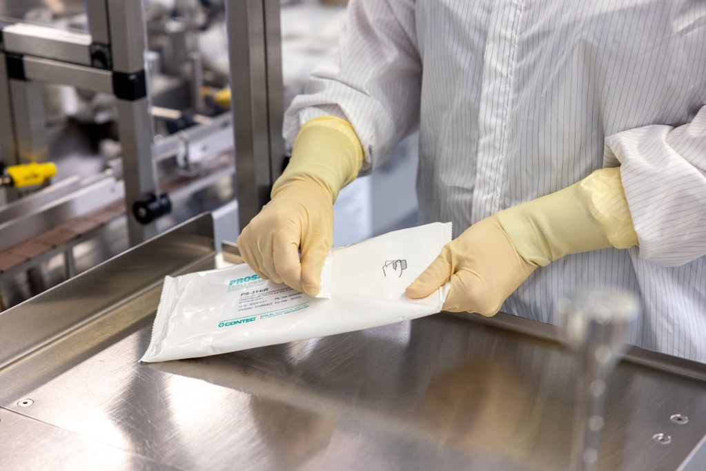 close up of gloves opening up box of sanitized wipes