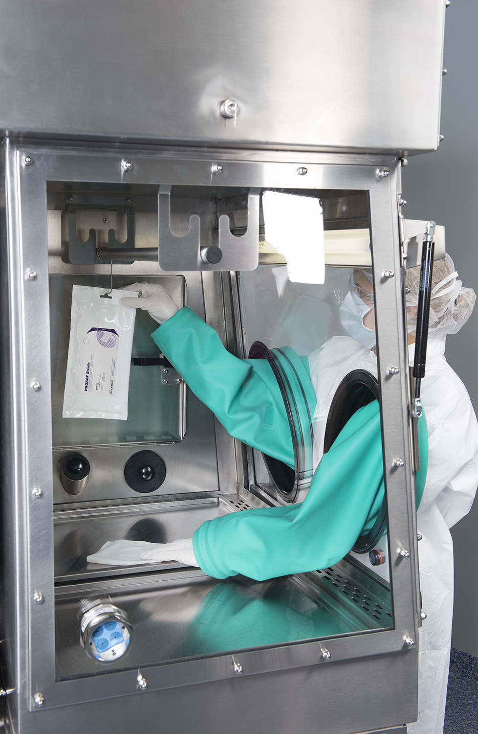 Cleanroom employee holding Contec wipes in a PEC unit.