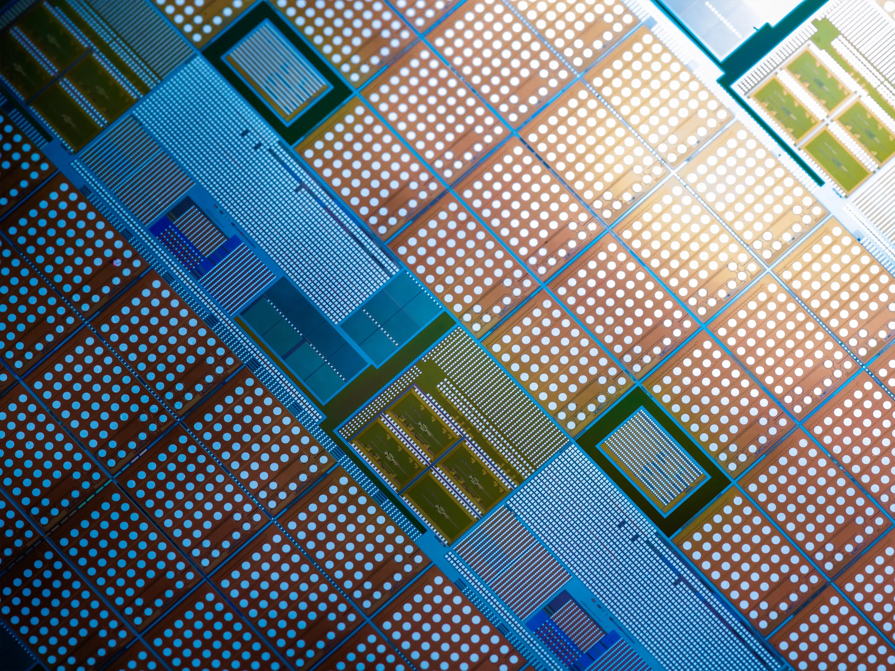Close-up of a semiconductor wafer with intricate integrated circuit patterns used in microelectronics manufacturing.